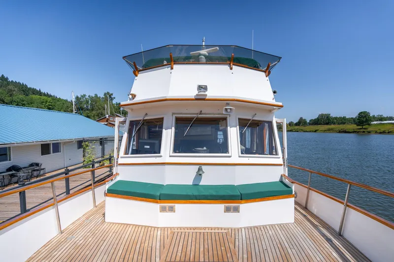 Slide: The Image of Grand Banks 52 Europa 1976 on calm river with blue sky. - 49