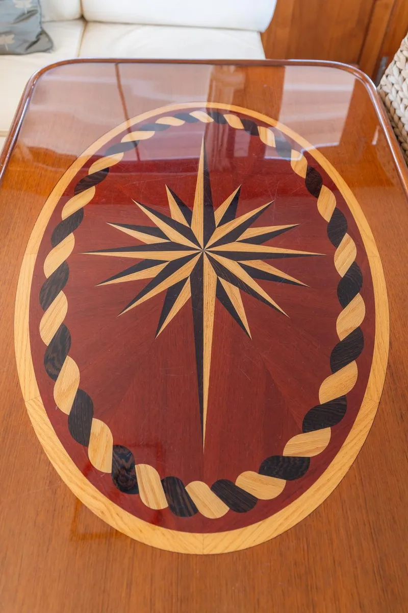 Slide: The Image of Wooden table with compass rose on Grand Banks 52 Europa, 1976 model. - 7