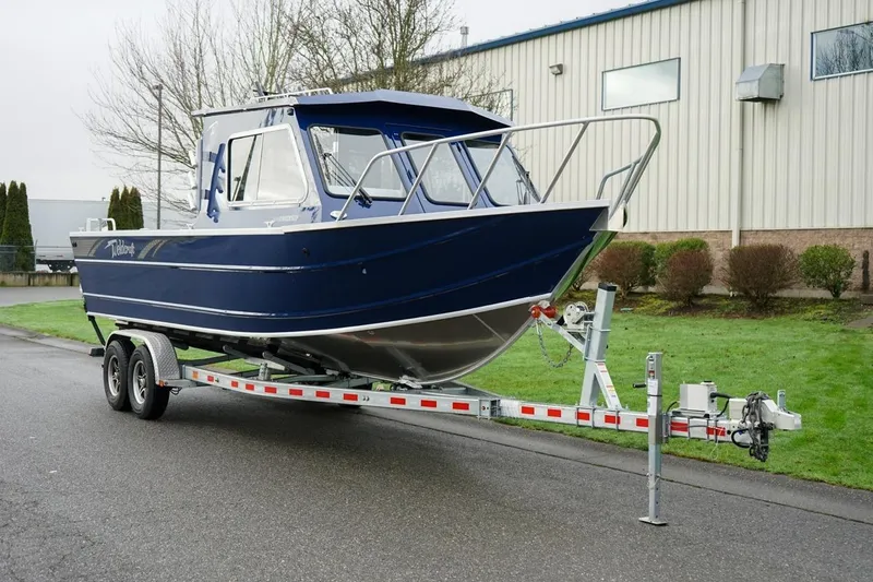 The Image of 2026 Weldcraft 260 Ocean King boat on trailer, parked outdoors near industrial building. - 1