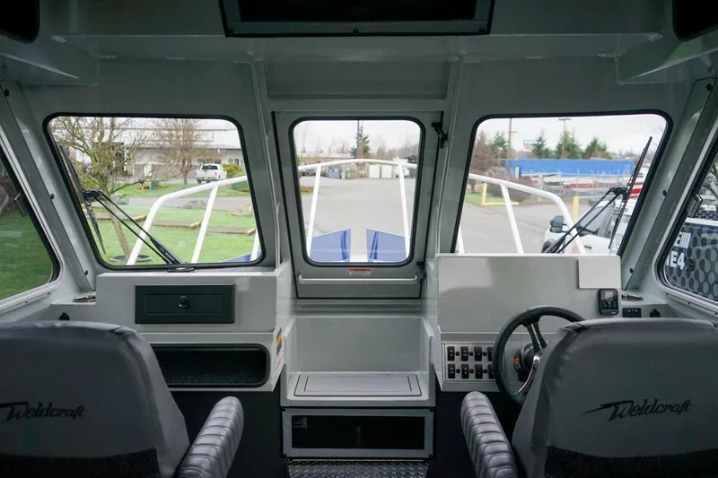 Slide: The Image of Interior view of 2026 Weldcraft 260 Ocean King boat cockpit with steering wheel. - 16