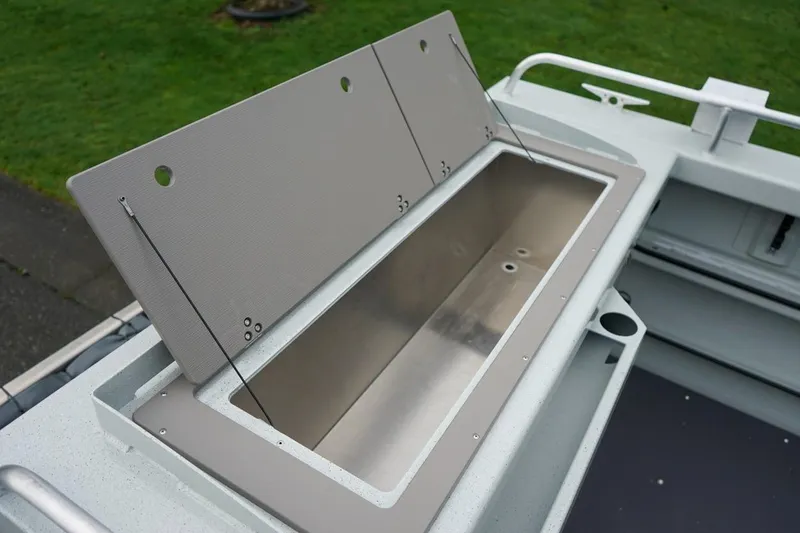 Slide: The Image of Open storage compartment on 2026 Weldcraft 260 Ocean King boat, showcasing sleek design. - 23