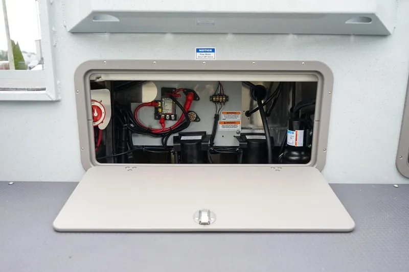 Slide: The Image of Electrical compartment of 2026 Weldcraft 260 Ocean King boat, showcasing wiring and components. - 24