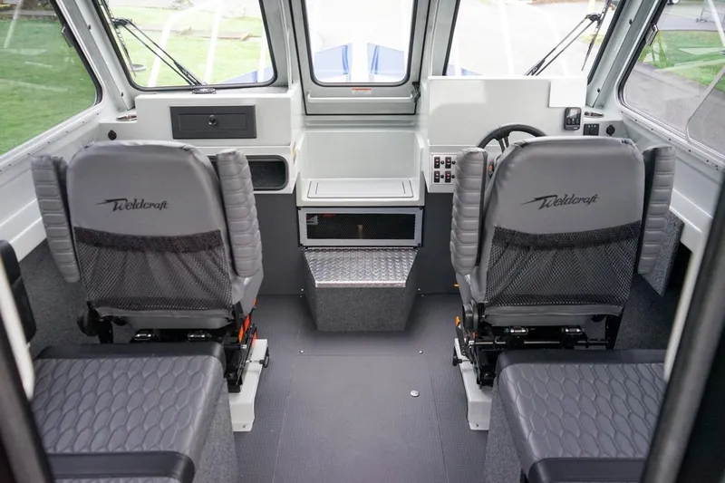 Slide: The Image of Interior of 2026 Weldcraft 260 Ocean King boat with dual captain chairs. - 8