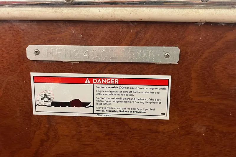 Slide: The Image of Skiff Craft 24' Runabout 2006 warning label on wooden surface, highlighting carbon monoxide danger. - 10