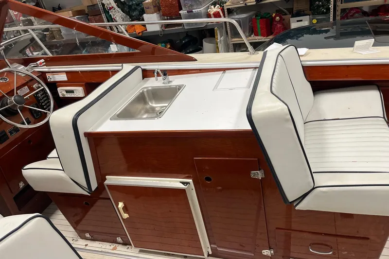 Slide: The Image of Interior of a 2006 Skiff Craft 24' Runabout with seating and sink. - 12