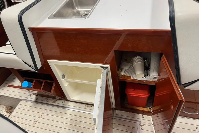 Slide: The Image of Interior of a 2006 Skiff Craft 24' Runabout with sink and storage cabinets. - 13