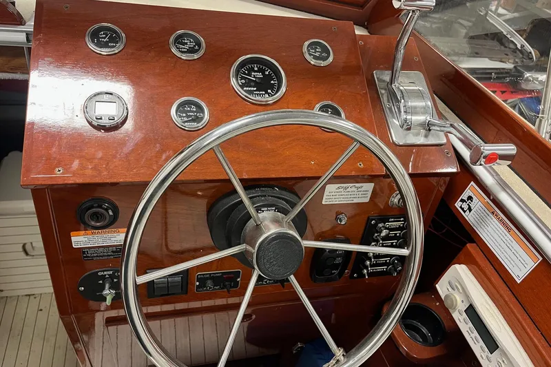 Slide: The Image of Steering wheel and controls of a 2006 Skiff Craft 24' Runabout boat. - 20