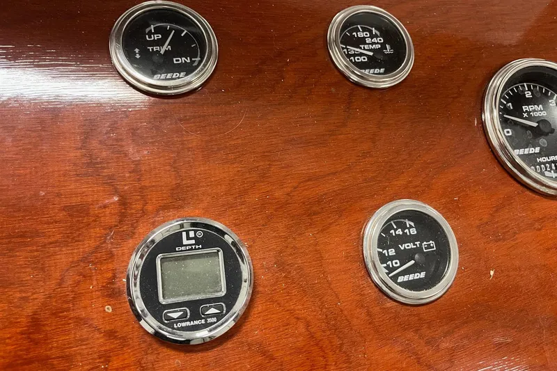 Slide: The Image of Dashboard of a 2006 Skiff Craft 24' Runabout with various gauges and instruments. - 21