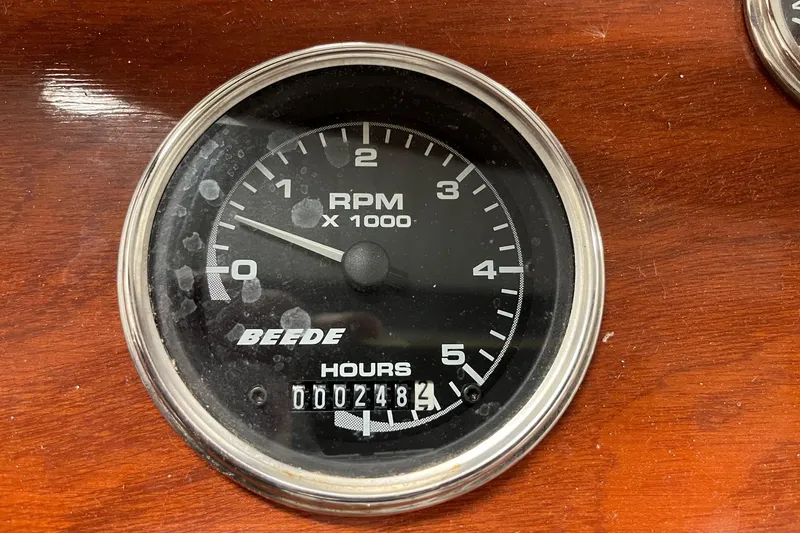 Slide: The Image of Tachometer of 2006 Skiff Craft 24' Runabout showing 248 hours on wooden dashboard. - 22