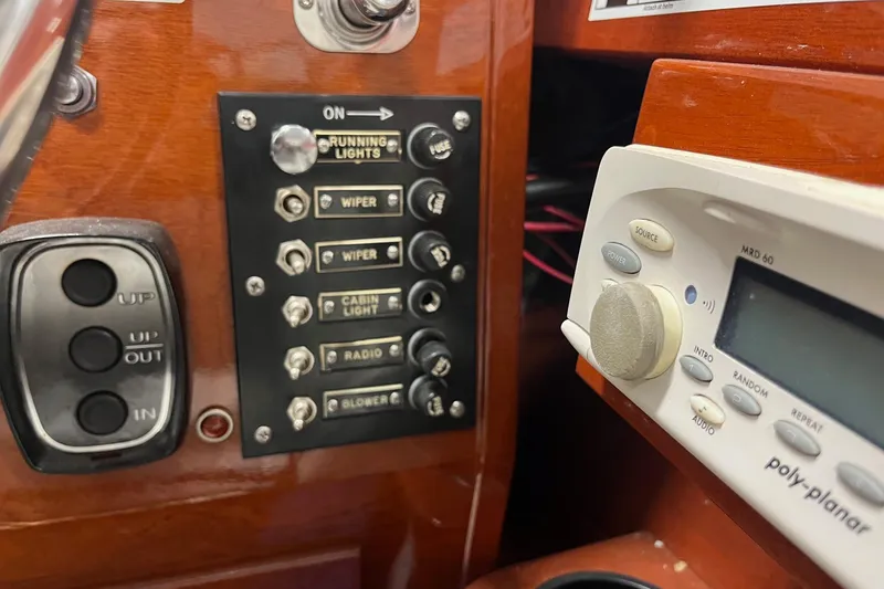 Slide: The Image of Control panel of a 2006 Skiff Craft 24' Runabout with switches and audio system. - 24