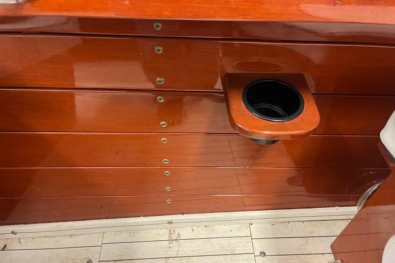 Slide: The Image of Polished wooden interior of a 2006 Skiff Craft 24' Runabout with cup holder. - 27