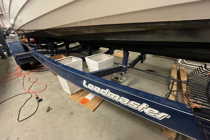Slide: The Image of 2006 Skiff Craft 24' Runabout on Loadmaster trailer in garage setting. - 5