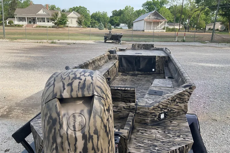 Slide: The Image of 2026 Excel 1751 Viper F4 boat with camouflage design parked outdoors. - 2