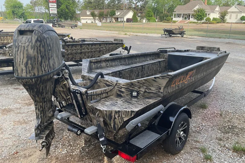 Slide: The Image of Camouflage-patterned 2026 Excel 1751 Viper F4 boat on trailer in outdoor setting. - 4