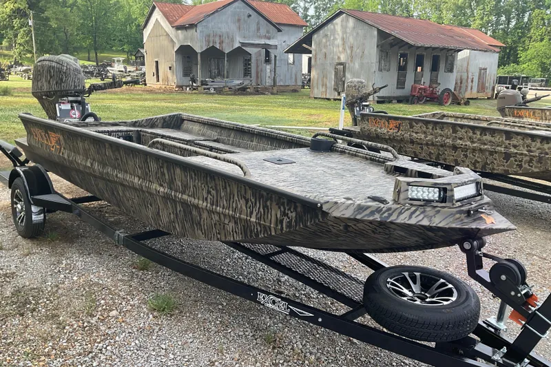 Slide: The Image of 2026 Excel 1751 Viper F4 boat on trailer, rustic background. - 5
