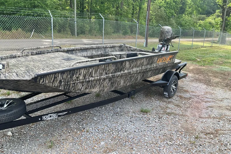 Slide: The Image of 2026 Excel 1751 Viper F4 boat with camouflage design on a trailer, parked outdoors. - 6
