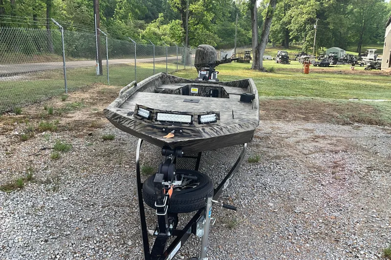 Slide: The Image of 2026 Excel 1751 Viper F4 boat on trailer, parked outdoors near a fence and trees. - 7