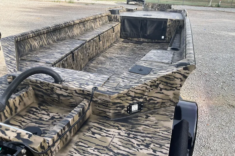 Slide: The Image of 2026 Excel 1751 Viper F4 boat with camouflage design on gravel surface. - 8