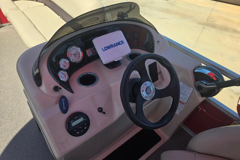 Slide: The Image of 2017 Sun Tracker Party Barge 18 DLX dashboard with steering wheel and Lowrance device. - 12