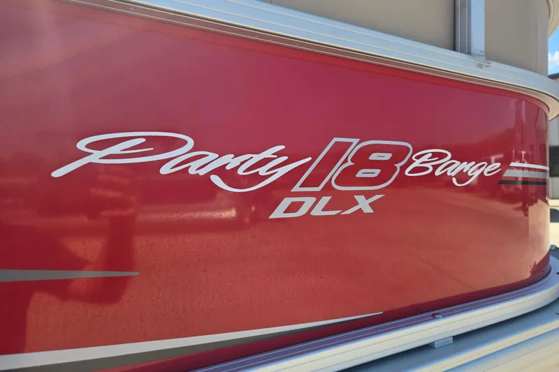 Slide: The Image of 2017 Sun Tracker Party Barge 18 DLX, red exterior with white lettering. - 17