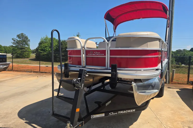 Slide: The Image of 2017 Sun Tracker Party Barge 18 DLX pontoon boat with red canopy on trailer. - 6