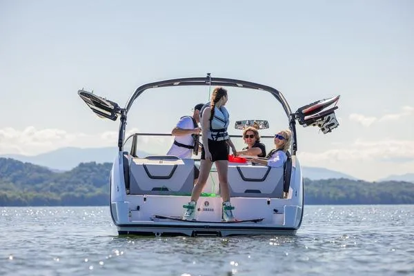 Slide: The Image of 2026 Yamaha Boats AR220 on water with people enjoying water sports. - 11