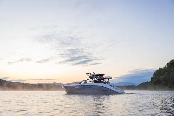 Slide: The Image of 2026 Yamaha Boats AR220 on serene lake at sunrise, surrounded by mist and trees. - 9