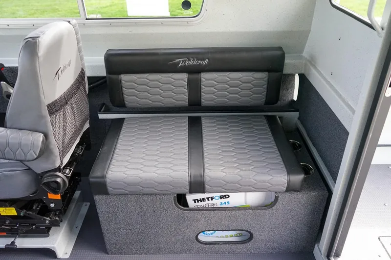 Slide: The Image of Interior seating of 2026 Weldcraft 220 Ocean King boat, featuring gray upholstery and storage. - 10