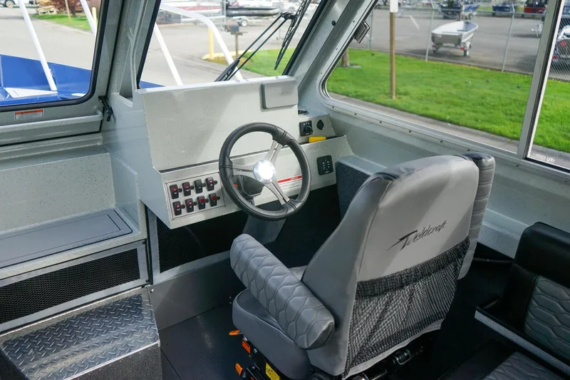 Slide: The Image of Interior of 2026 Weldcraft 220 Ocean King boat, featuring steering wheel and control panel. - 14