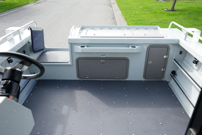 Slide: The Image of 2026 Weldcraft 220 Ocean King boat interior with steering wheel and storage compartments. - 6