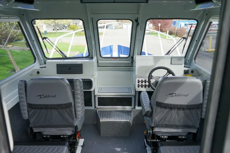 Slide: The Image of Interior of 2026 Weldcraft 220 Ocean King boat, featuring dual seats and control panel. - 9