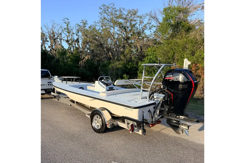 The Image of 2025 Chittum Skiffs Islamorada 21 boat on trailer, parked outdoors. - 1