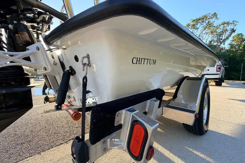 Slide: The Image of 2025 Chittum Skiffs Islamorada 21 boat on trailer, showcasing sleek design and craftsmanship. - 11