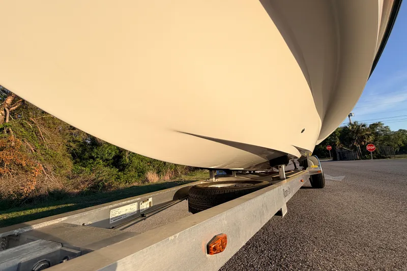 Slide: The Image of 2025 Chittum Skiffs Islamorada 21 boat on trailer, viewed from below, outdoors. - 18