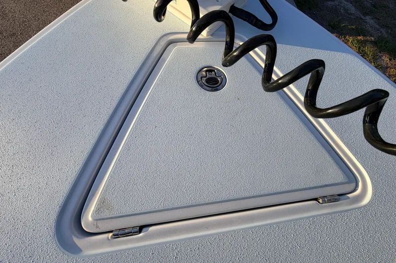 Slide: The Image of 2025 Chittum Skiffs Islamorada 21 deck hatch with coiled cable. - 23