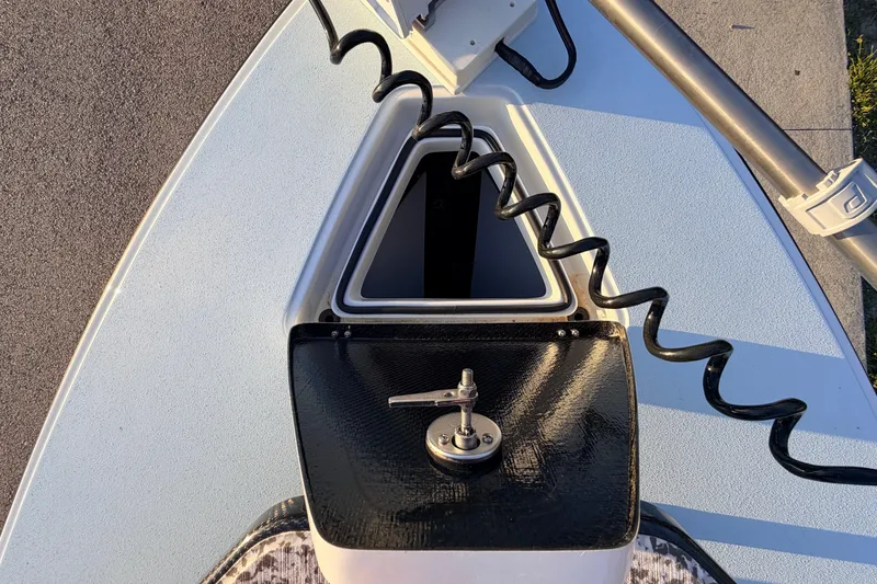 Slide: The Image of 2025 Chittum Skiffs Islamorada 21 bow with open hatch and coiled cable. - 24