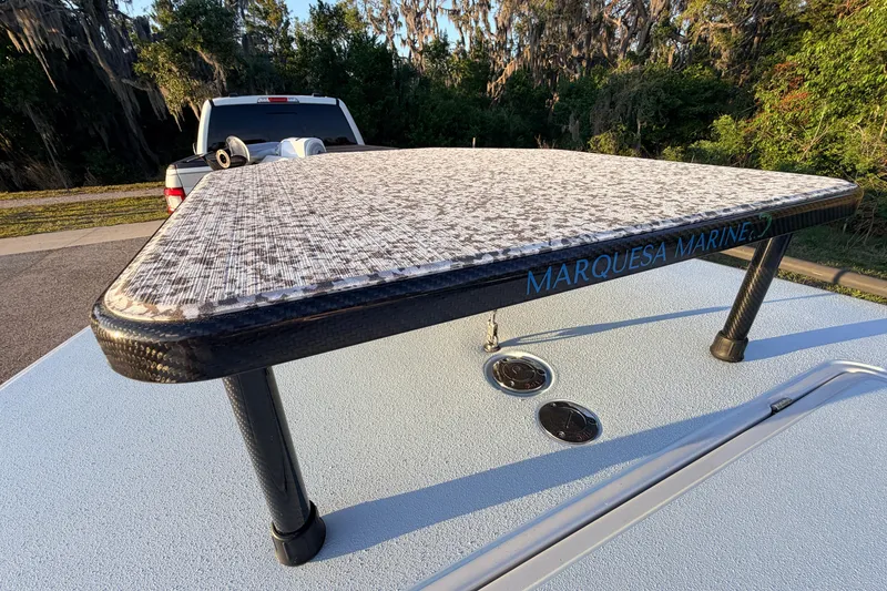 Slide: The Image of 2025 Chittum Skiffs Islamorada 21 with Marquesa Marine platform, parked outdoors. - 27