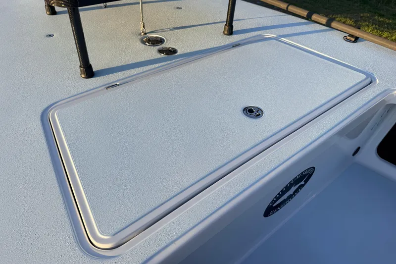 Slide: The Image of 2025 Chittum Skiffs Islamorada 21 deck with storage compartment and sleek design. - 29