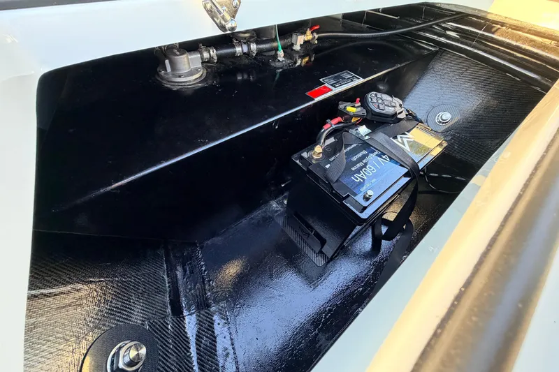 Slide: The Image of Battery compartment of 2025 Chittum Skiffs Islamorada 21, showcasing wiring and components. - 32
