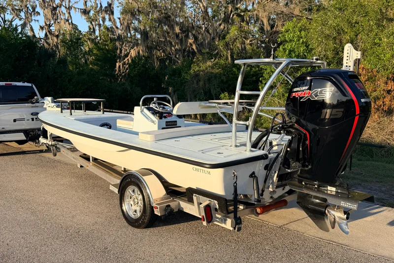 Slide: The Image of 2025 Chittum Skiffs Islamorada 21 boat on trailer, featuring Mercury Pro XS 115 engine. - 4