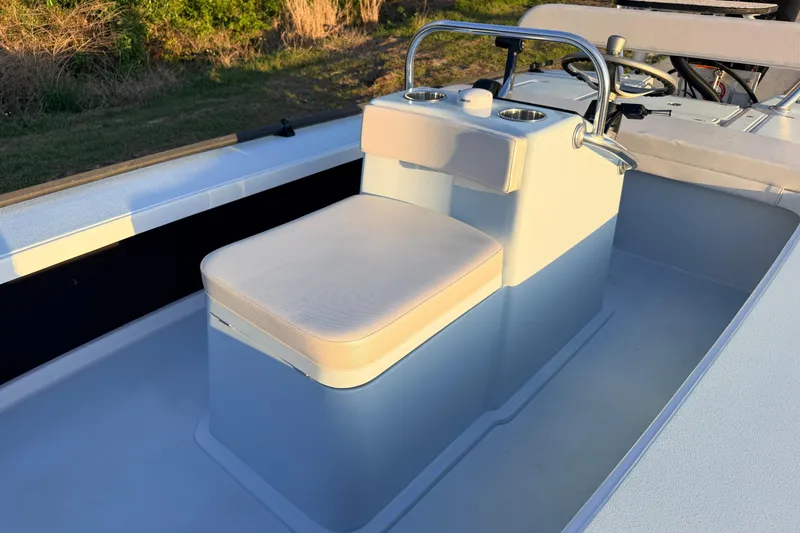 Slide: The Image of 2025 Chittum Skiffs Islamorada 21 boat interior with cushioned seating and steering console. - 43