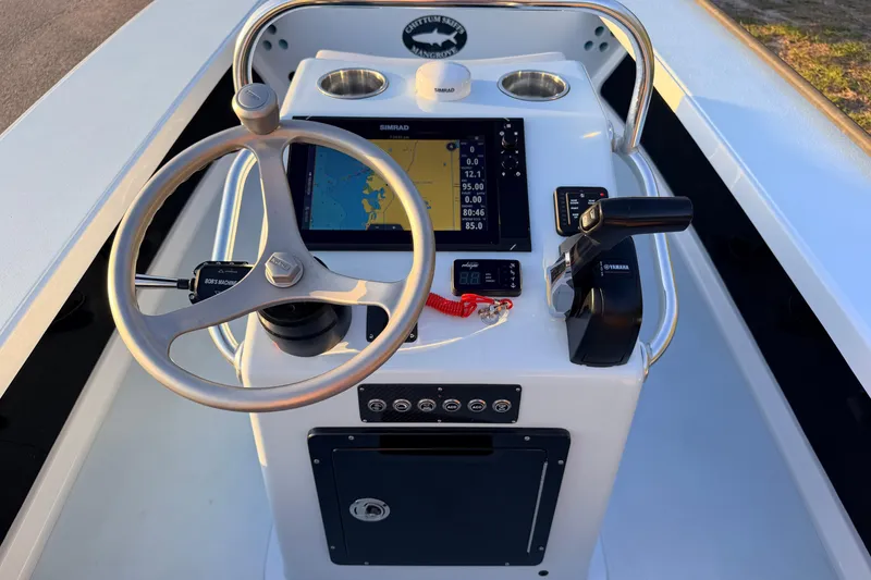 Slide: The Image of 2025 Chittum Skiffs Islamorada 21 boat console with steering wheel and navigation display. - 44