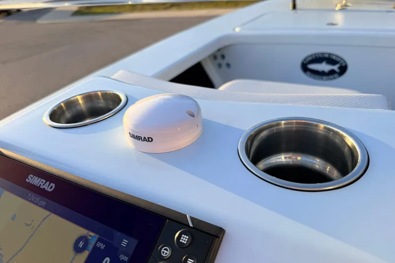 Slide: The Image of 2025 Chittum Skiffs Islamorada 21 dashboard with Simrad electronics and cup holders. - 45