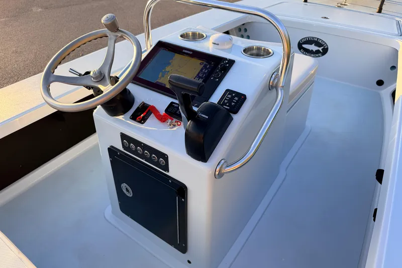 Slide: The Image of 2025 Chittum Skiffs Islamorada 21 boat console with steering wheel and navigation system. - 46