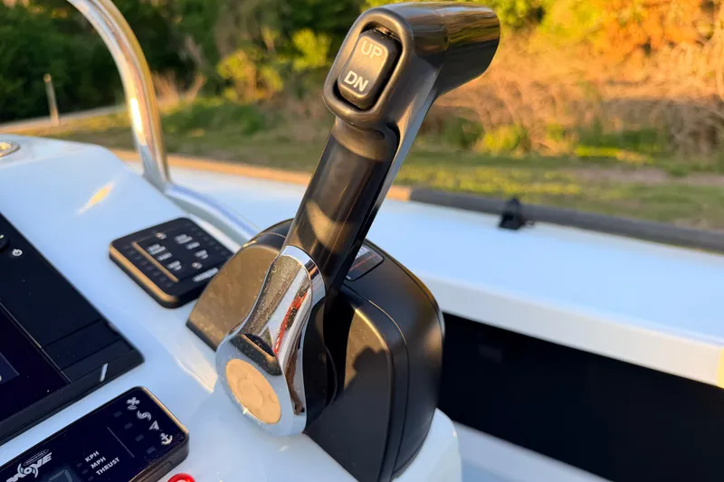 Slide: The Image of Throttle control on 2025 Chittum Skiffs Islamorada 21 boat, close-up view. - 48