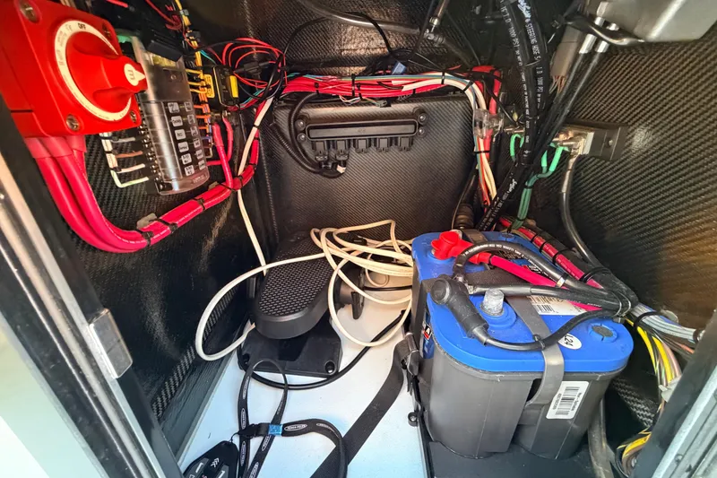 Slide: The Image of Electrical system inside a 2025 Chittum Skiffs Islamorada 21 boat, featuring wiring and battery. - 55