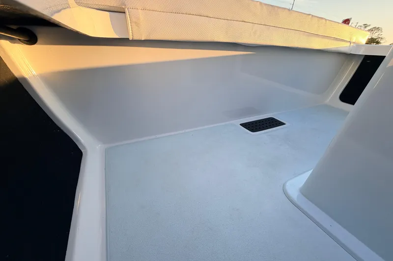 Slide: The Image of 2025 Chittum Skiffs Islamorada 21 interior detail with sunlight highlighting sleek design. - 57
