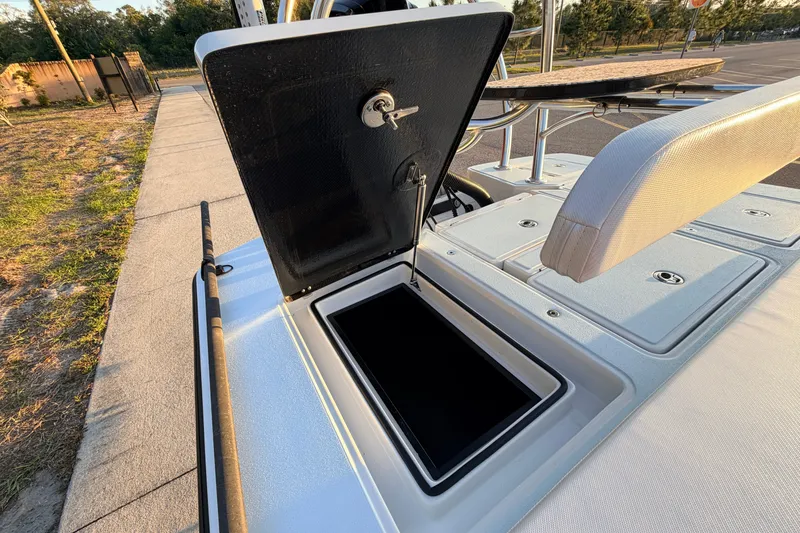 Slide: The Image of Open storage compartment on 2025 Chittum Skiffs Islamorada 21 boat, showcasing sleek design. - 62