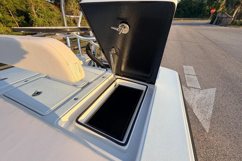 Slide: The Image of 2025 Chittum Skiffs Islamorada 21 boat with open storage compartment on deck. - 68