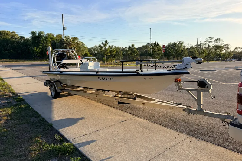 Slide: The Image of 2025 Chittum Skiffs Islamorada 21 boat on trailer in parking lot. - 7